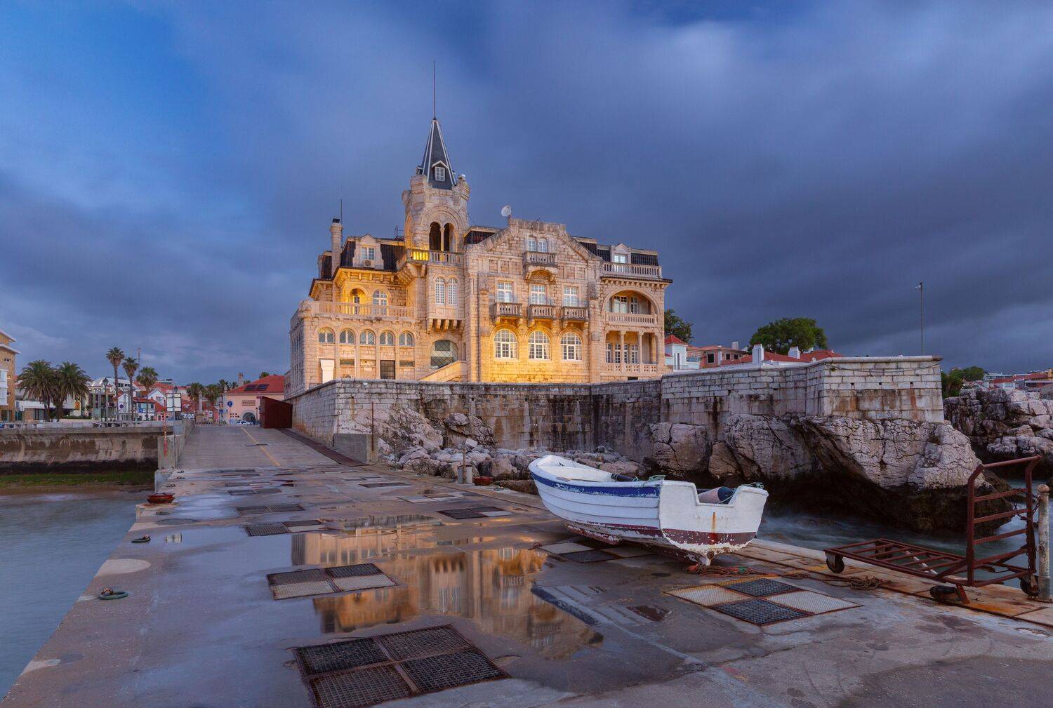 Santa Marta waterfront mansion under storm clouds in Cascais Portugal