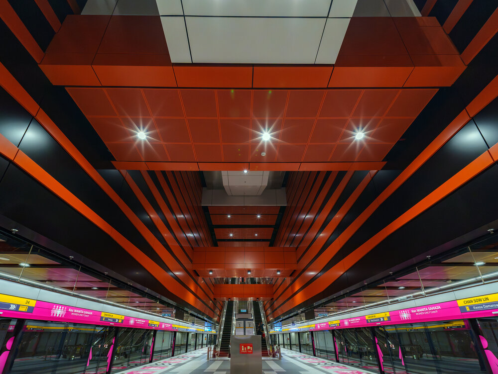 Modern Subway Station with Bold Orange Geometric Ceiling