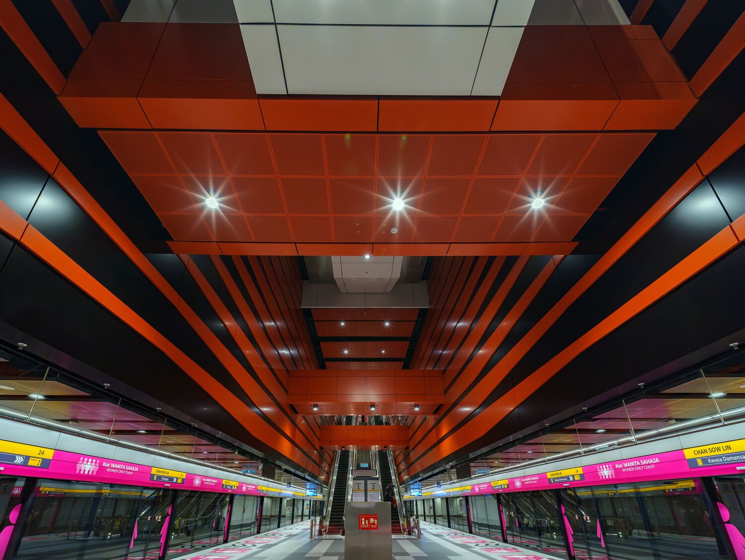 Modern Subway Station with Bold Orange Geometric Ceiling