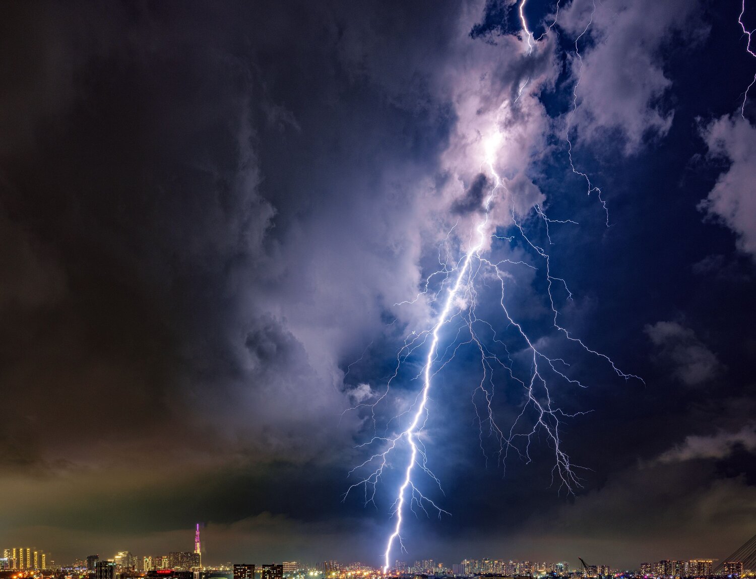 Dramatic Lightning Strike Over City Skyline at Night