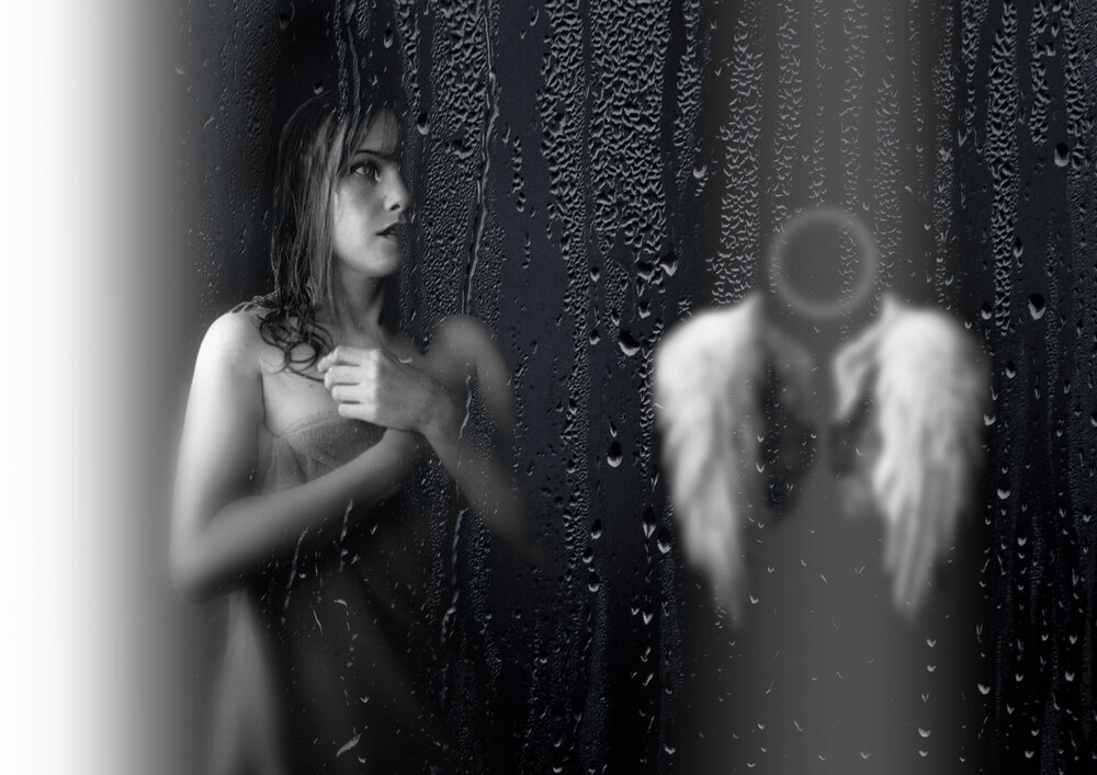 A beautiful detailed close up black and white portrait photograph showing a sad woman behind wet window glass next to abstract blurred angel wings