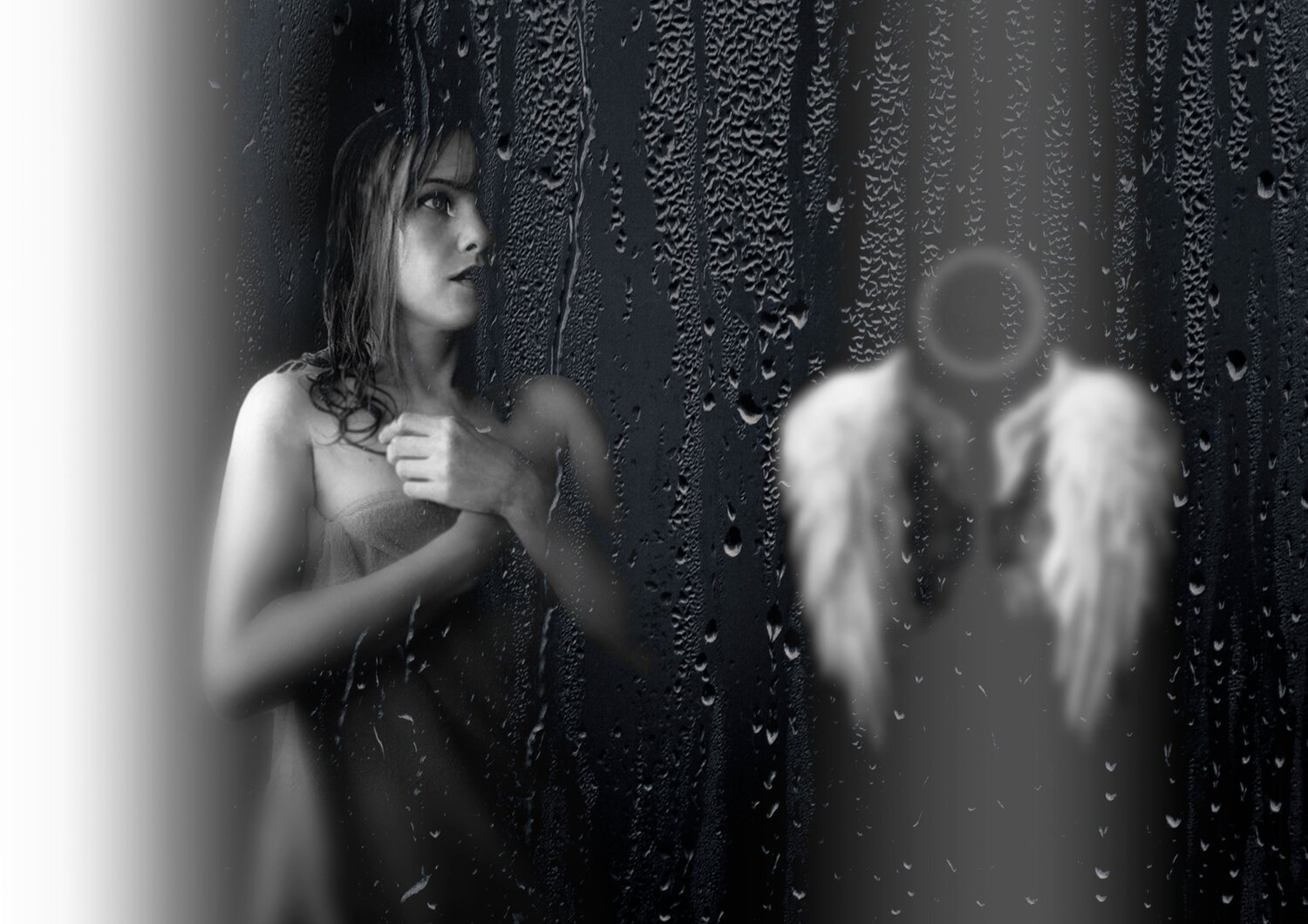 A beautiful detailed close up black and white portrait photograph showing a sad woman behind wet window glass next to abstract blurred angel wings