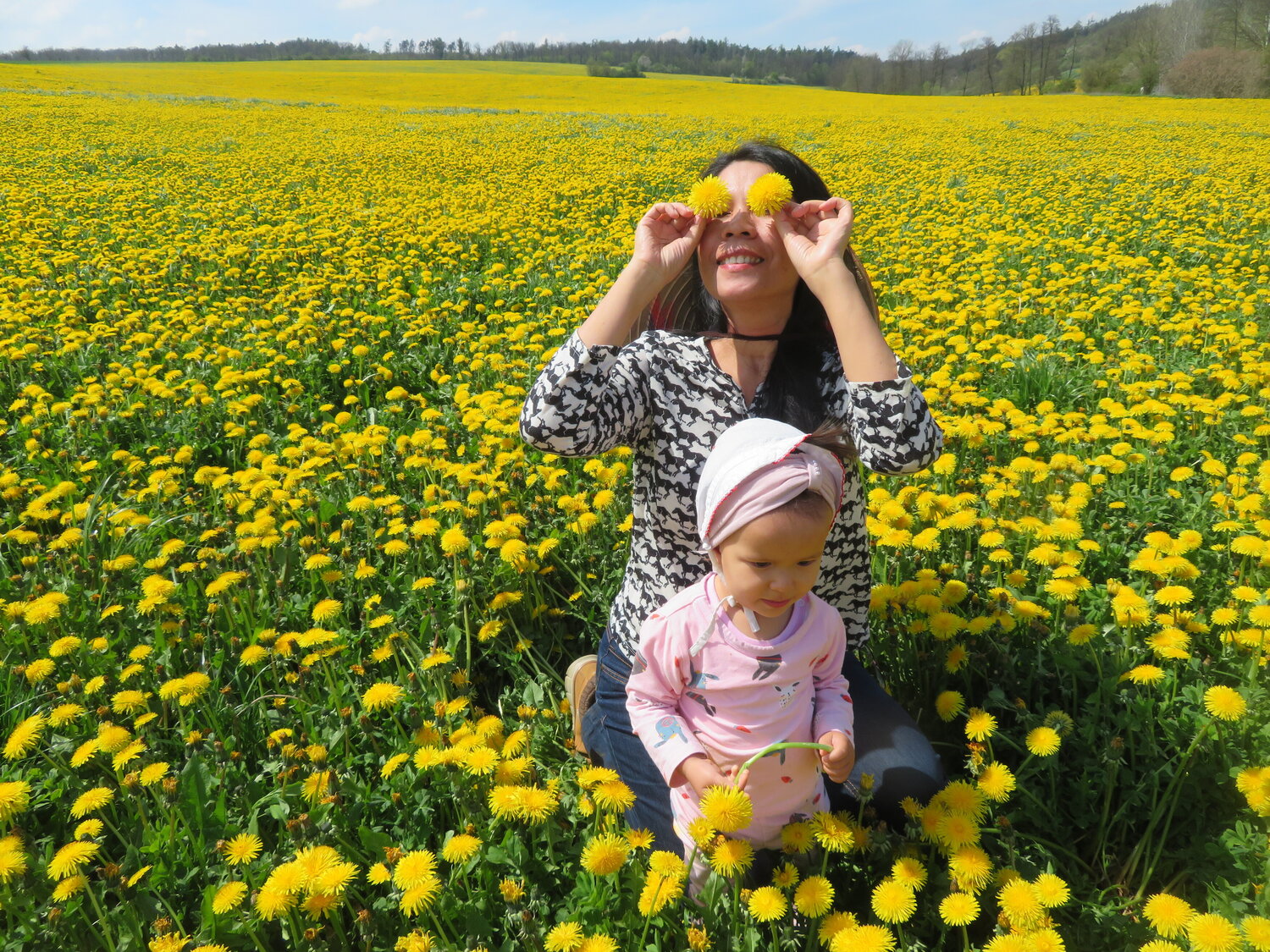 Mother and child in dandelion field