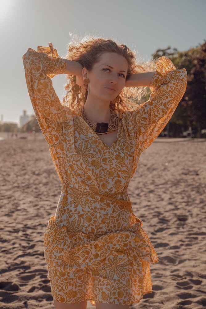Golden Hour — warm sunlight highlighting the intricate pattern of the dress.