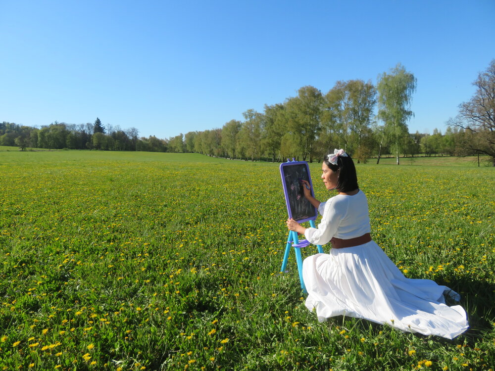 Artist Painting In Yellow Flower Field Under Blue Sky