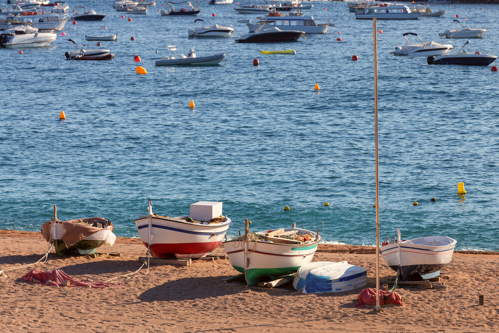 Traditional Fishing Boats on Sandy Beach in Tossa de Mar, Spain
