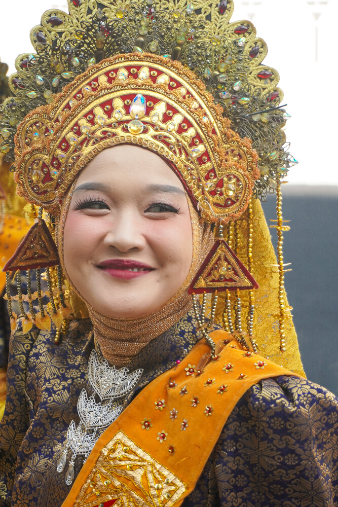 Portrait of Smiling Woman in Ornate Minangkabau Traditional Attire (Suntiang)