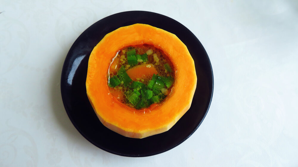 Orange Pumpkin Soup Served in Hollowed Pumpkin Bowl
