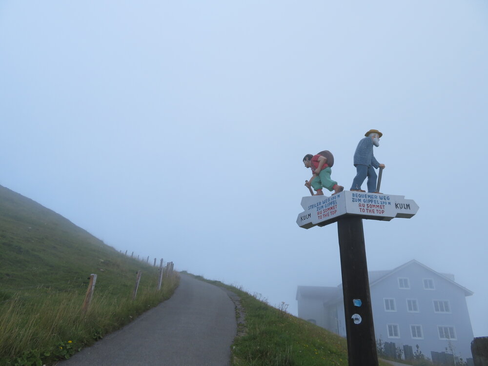 Conceptual Road Sign with Hiker Statues Journey and Choice