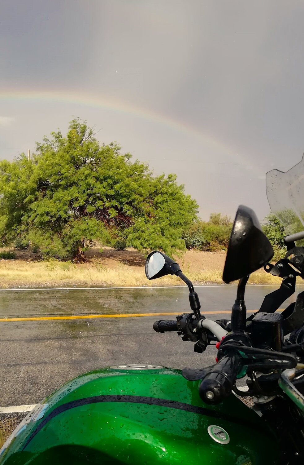 Rainbow, rain and motorbike