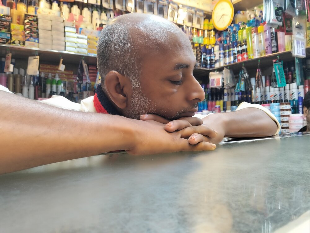 The Quiet Pause: A Shopkeeper\'s Rest
