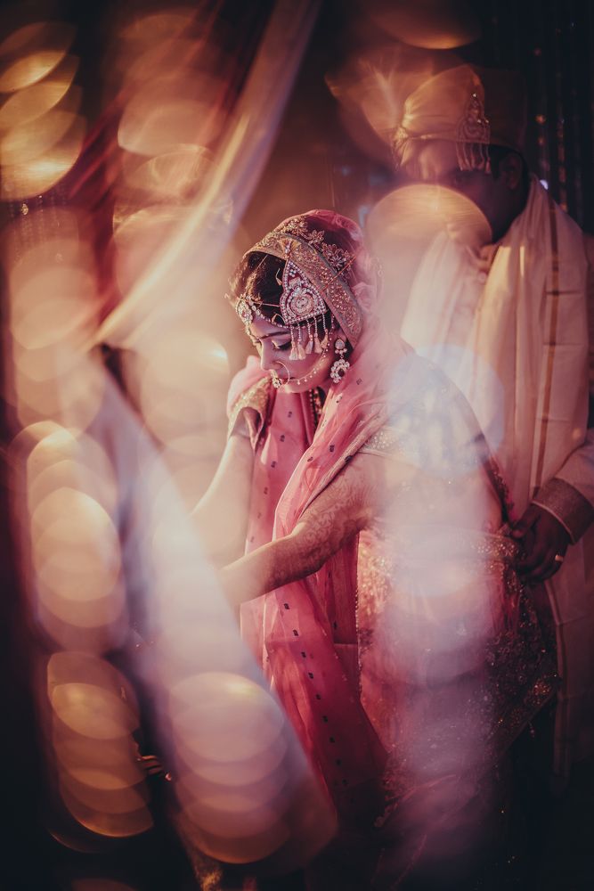 Bride through the jewelled curtains.