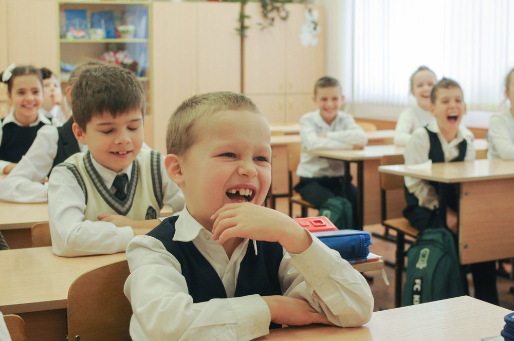 A laughing boy in the classroom