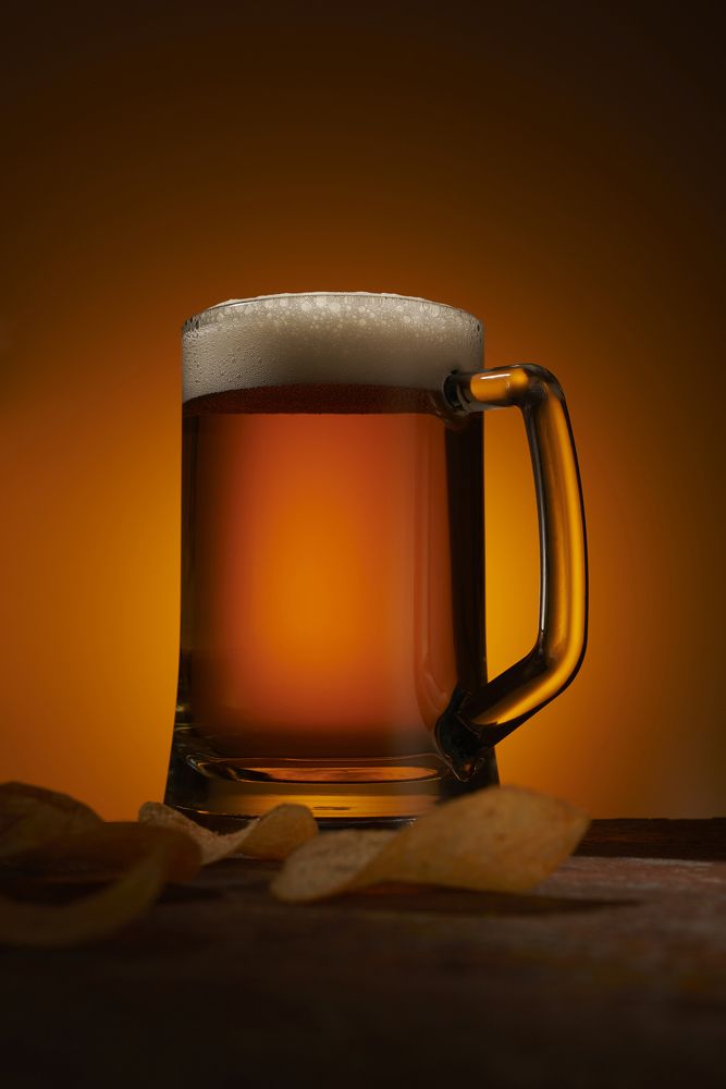 Glass of beer on a metal table