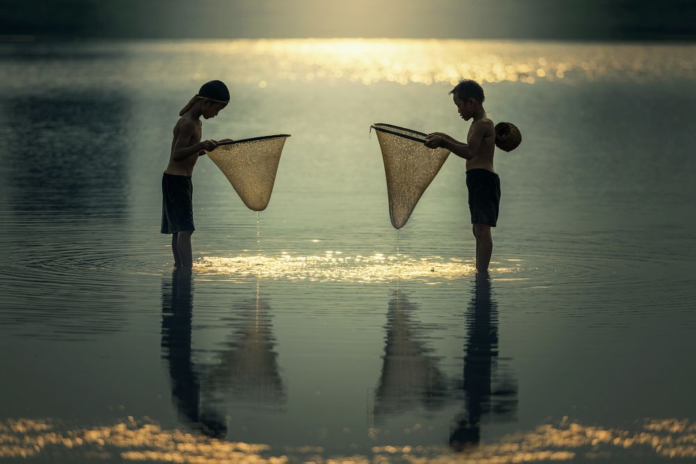 Asian boys fishing at the river