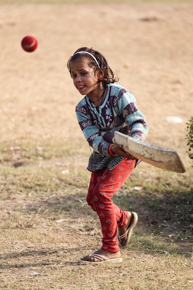 Young girl playing cricket in India