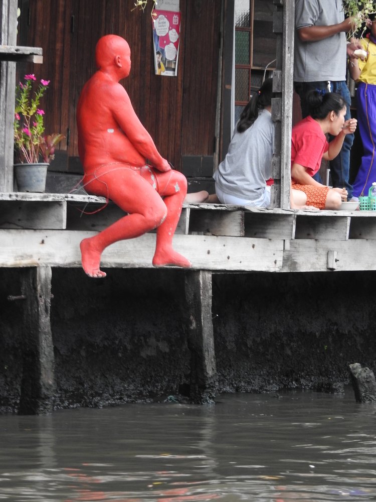 Human statue by the river