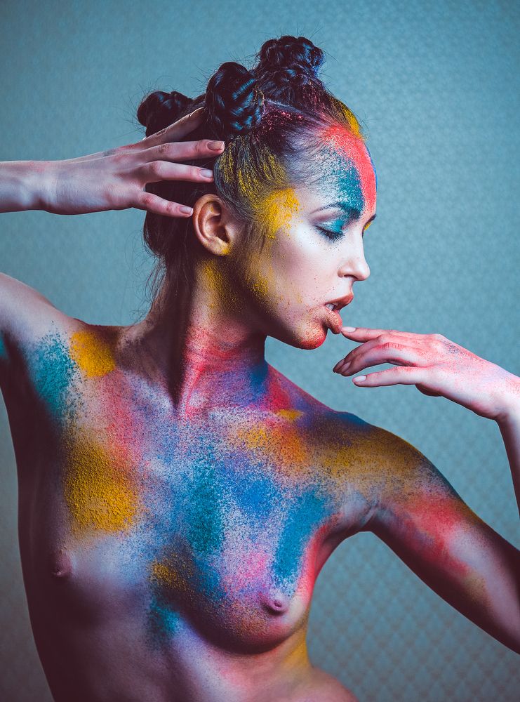The young nude girl in colorful powder.