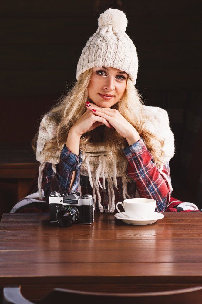 Alisa with old camera in cafe