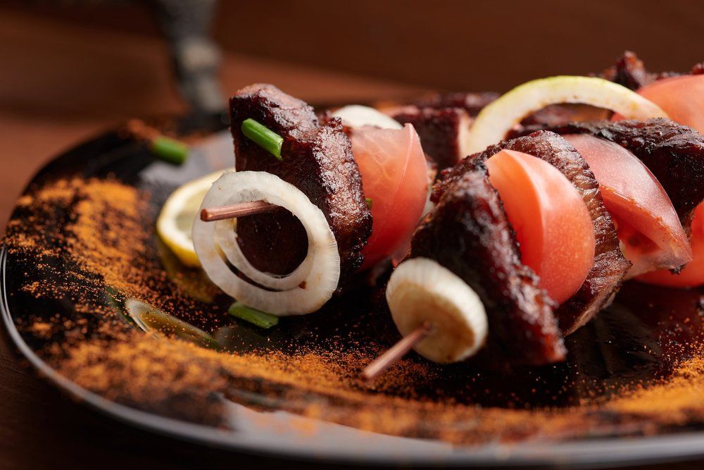 shish kebab on a plate on a wooden table