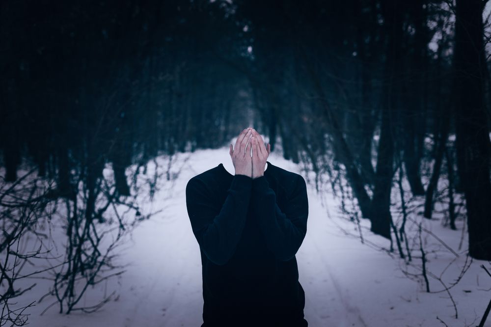 Lost sad boy hiding from people.