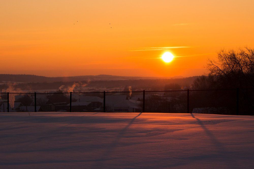 Winter evening landscape with yellow and purple sunset