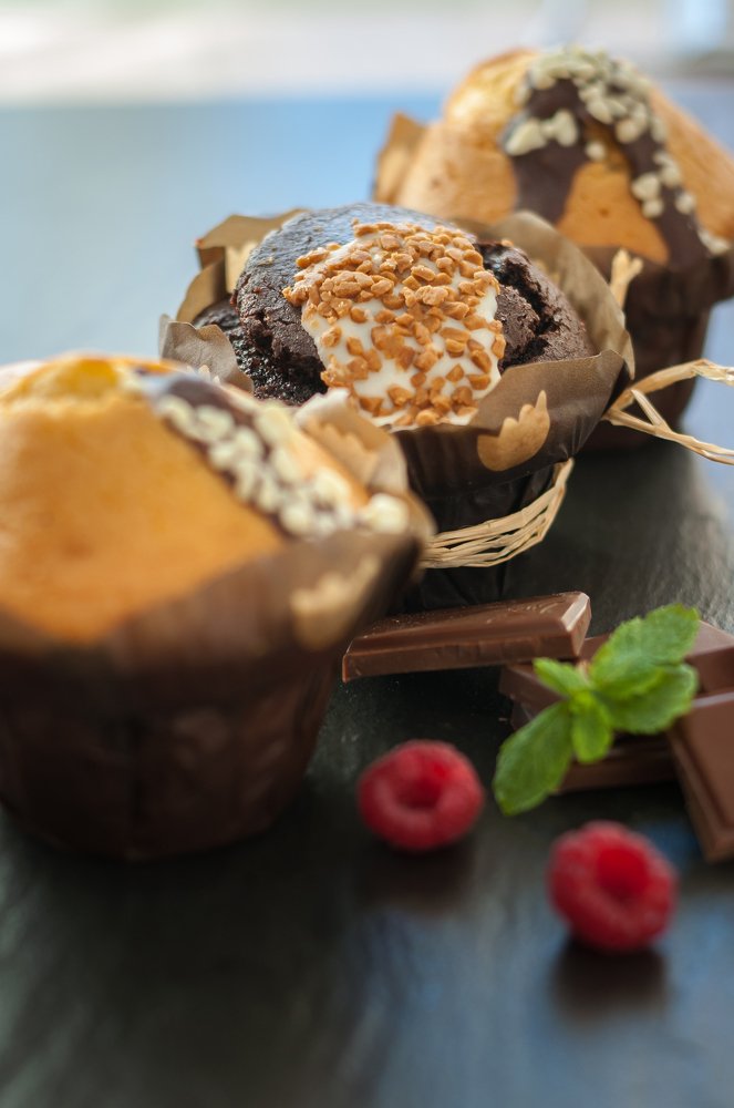 three muffin with raspberries and chocolate