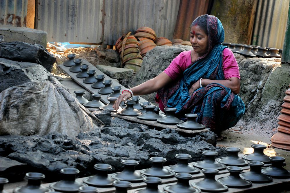 A woman works earthen pot ..