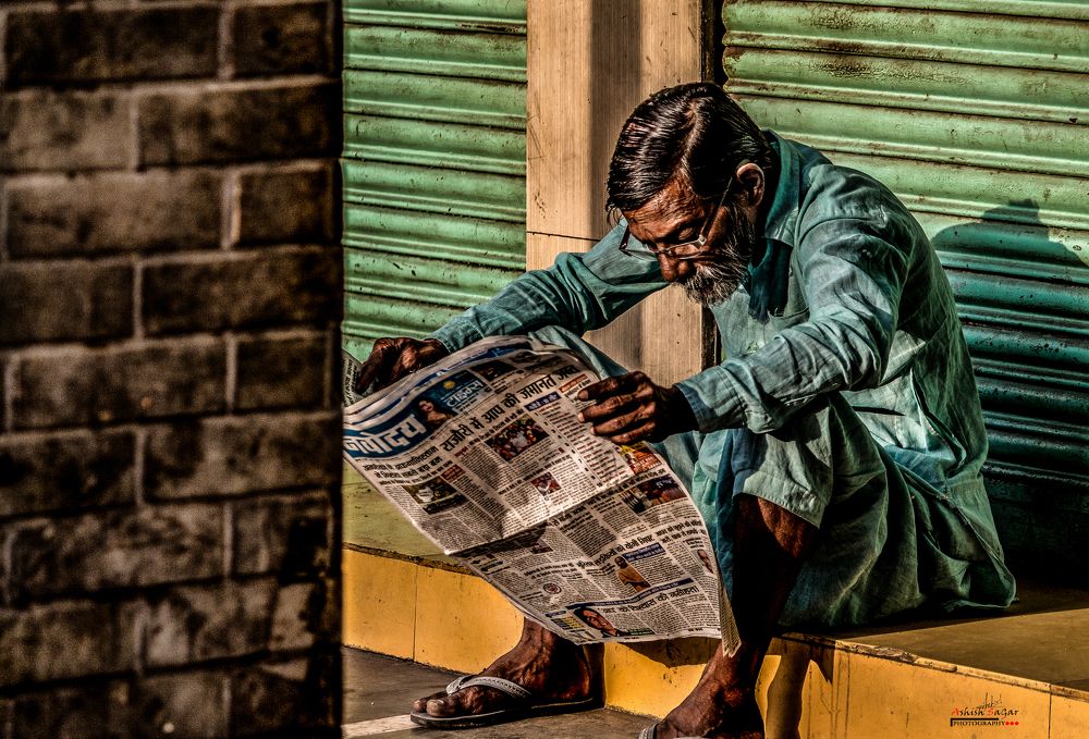 A man Early In the Morning Read a News Paper