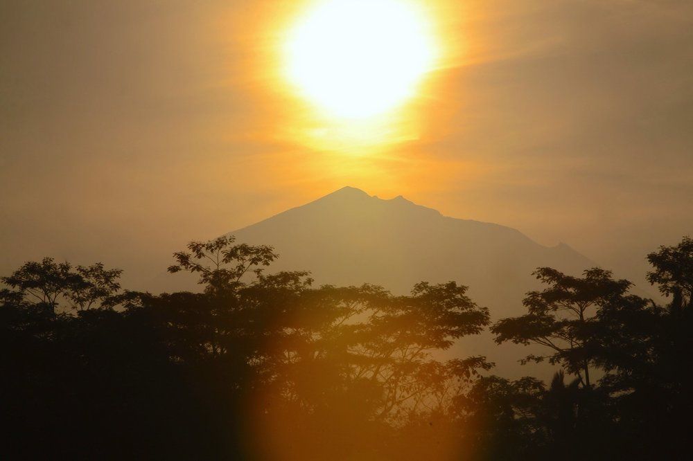 The sun peeked at the top of Mount Batur. Bali