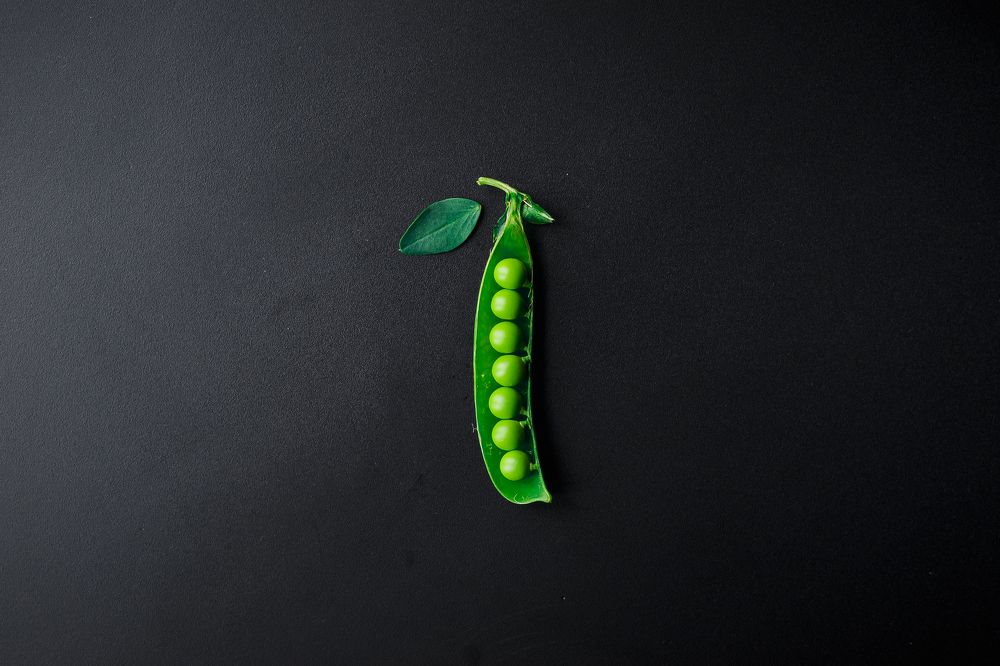 green peas on a black background.