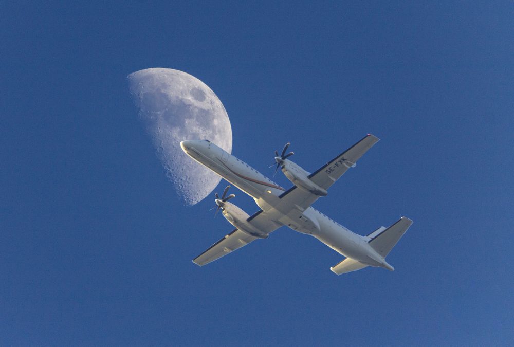 plane under the moon