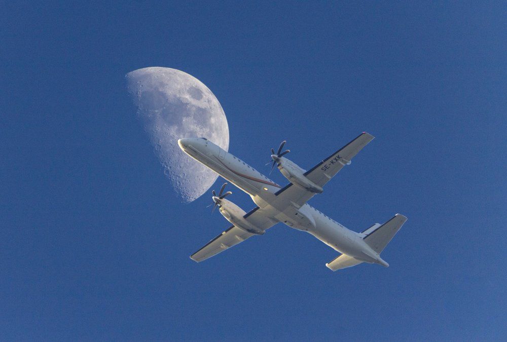 plane under the moon