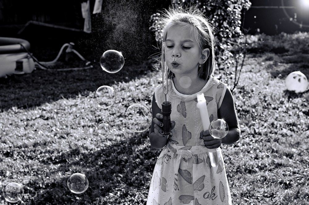 Little girl with soap bubbles
