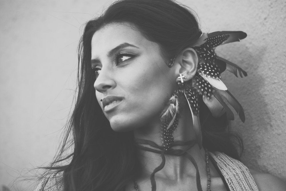 With feathers in her hair