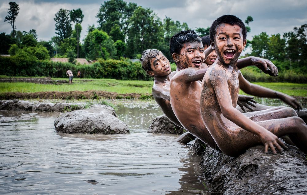 kids are playing on mud
