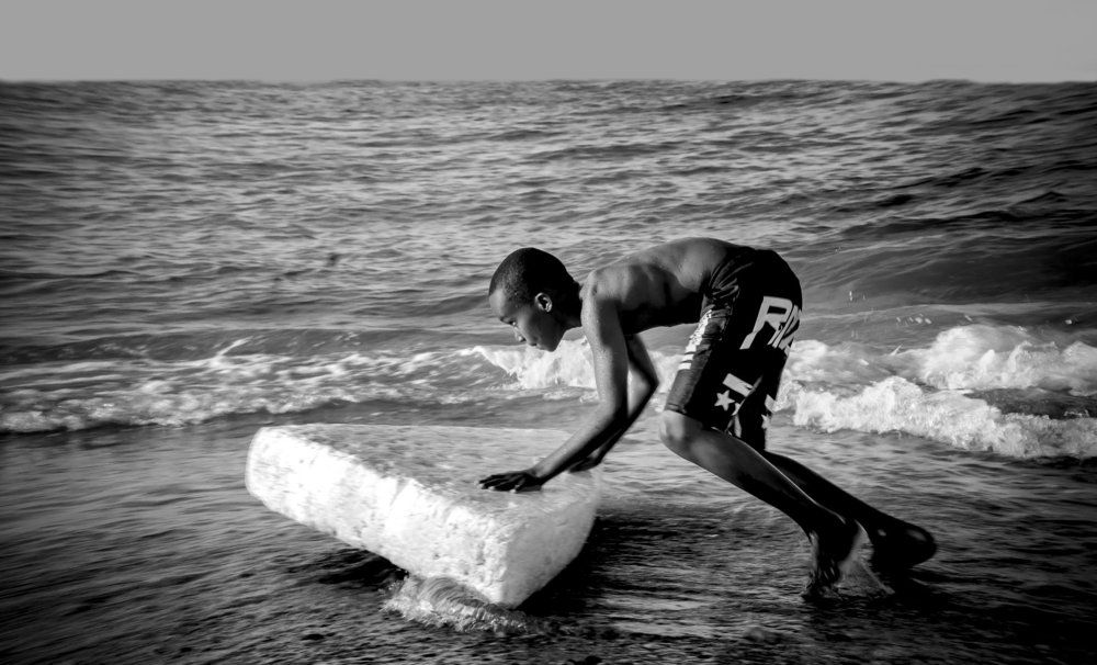 A boy playing on the beach .