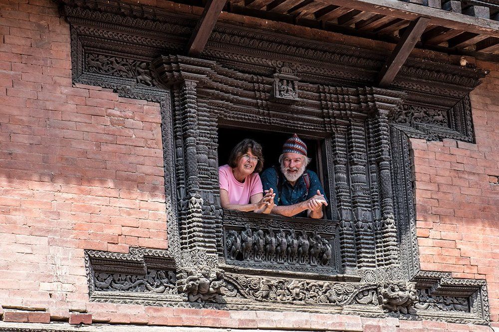 COUPLE IN DECORATED WINDOW
