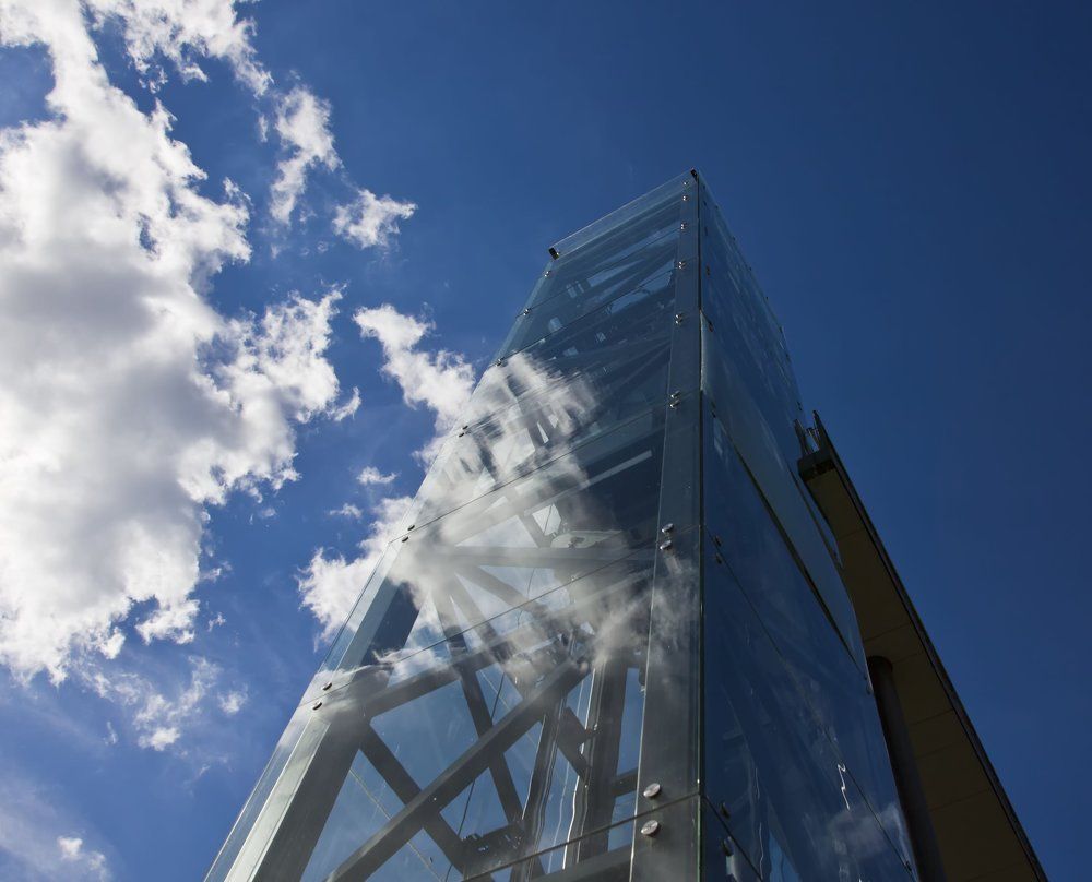 Reflection of clouds in a glass tower