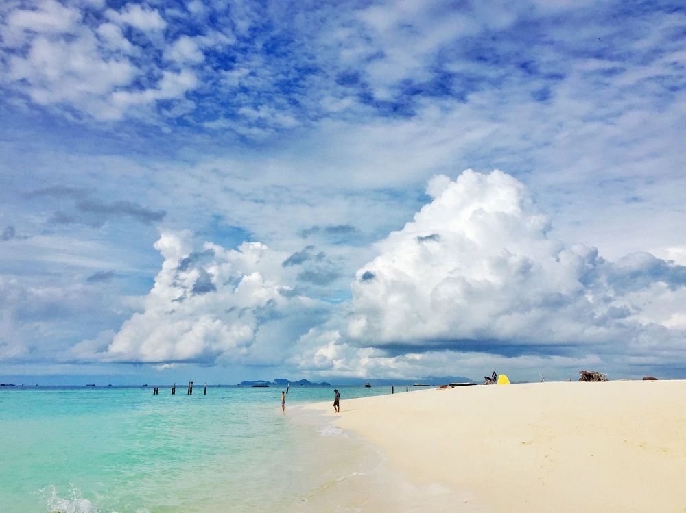 Paradise beach with lush clouds