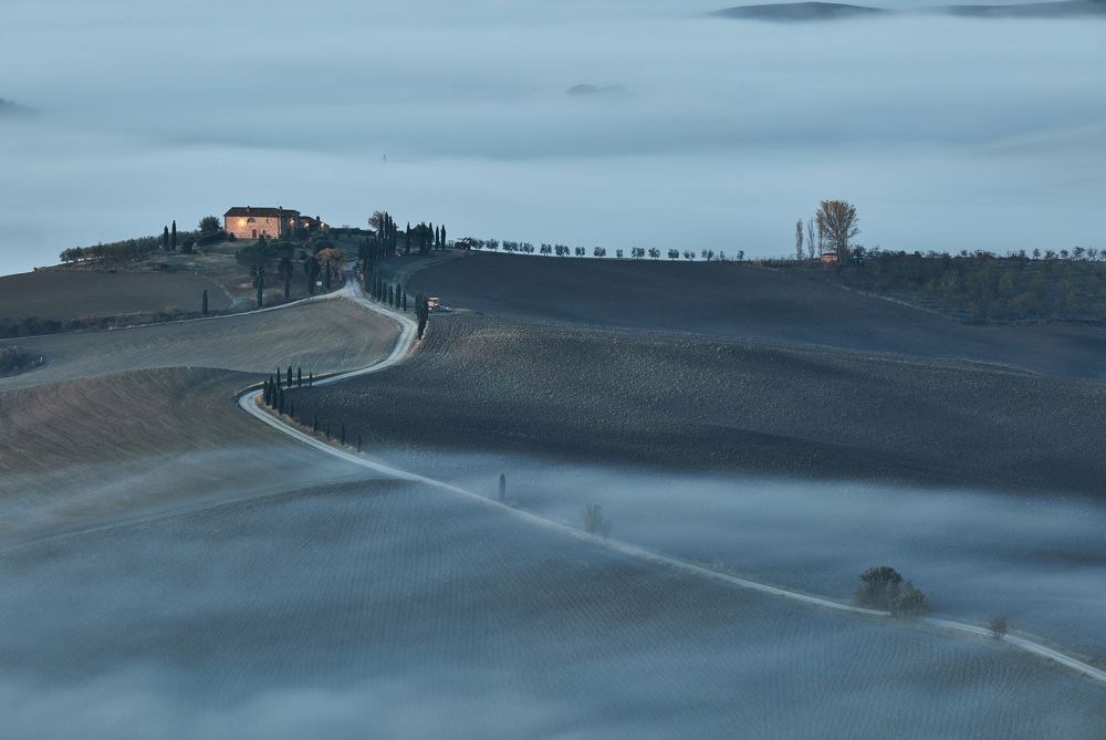 Tuscany under the fog at sunrise