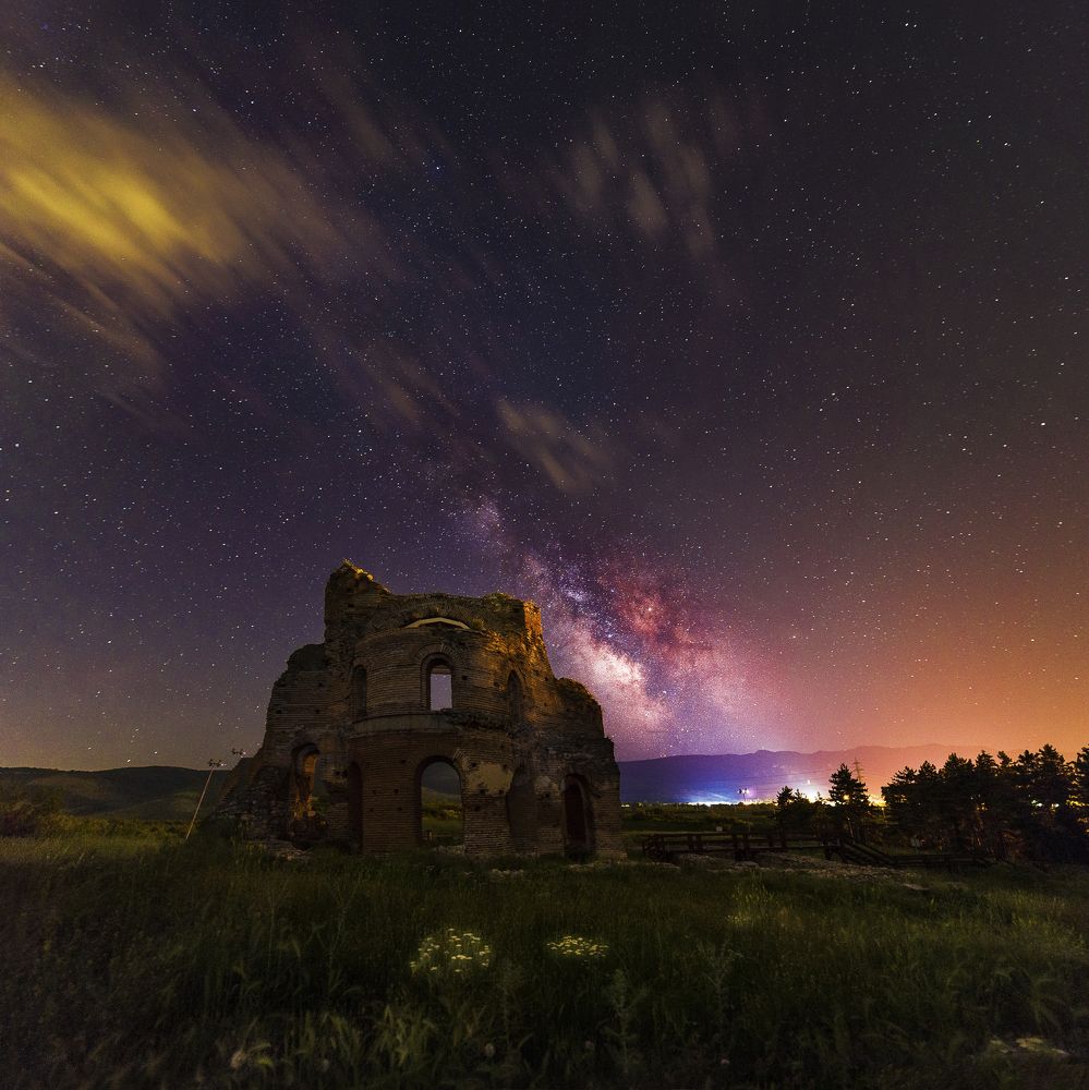 Red church under milky way.