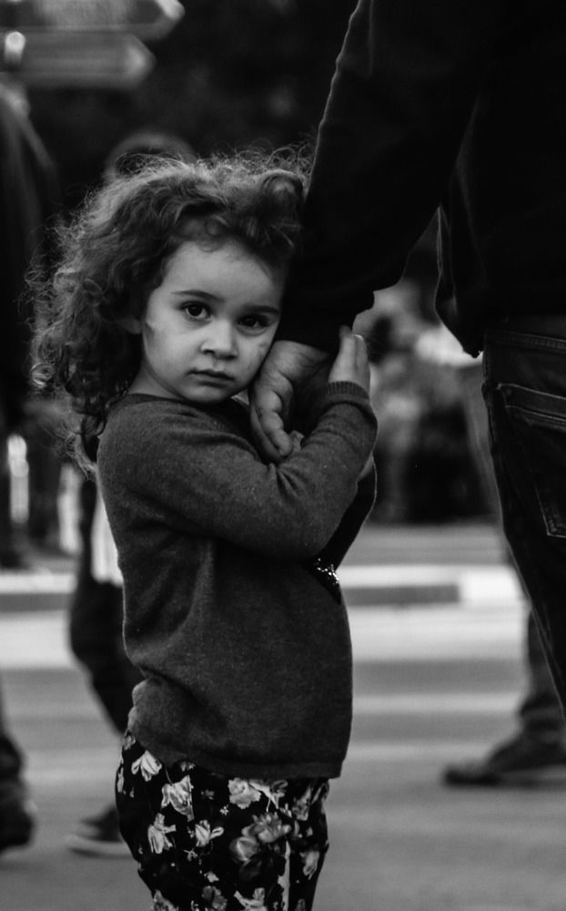 Little girl holds her father's hand