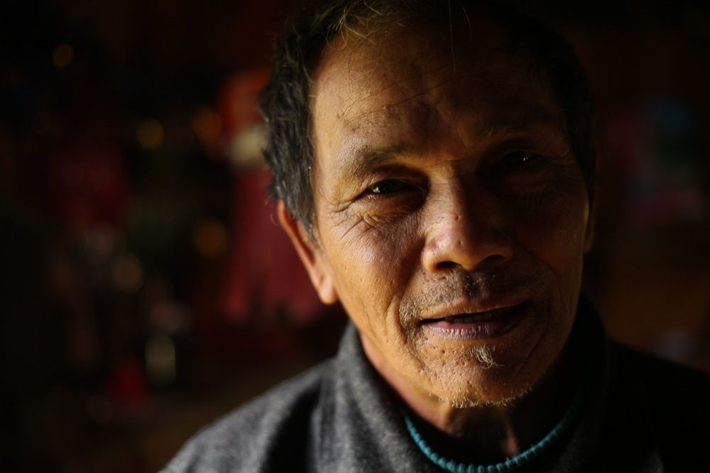Palaung man in his home, Myanmar