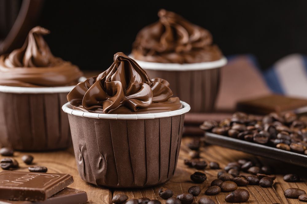 Homemade chocolate cupcakes on wooden background