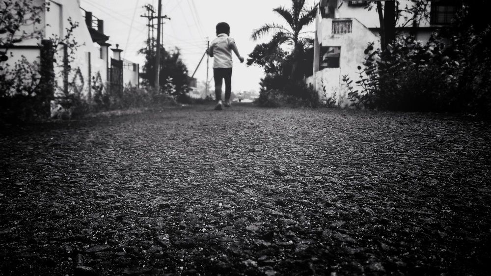 A child runninng on a road