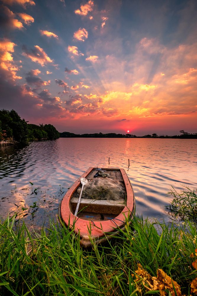 lonely boat waiting sunset