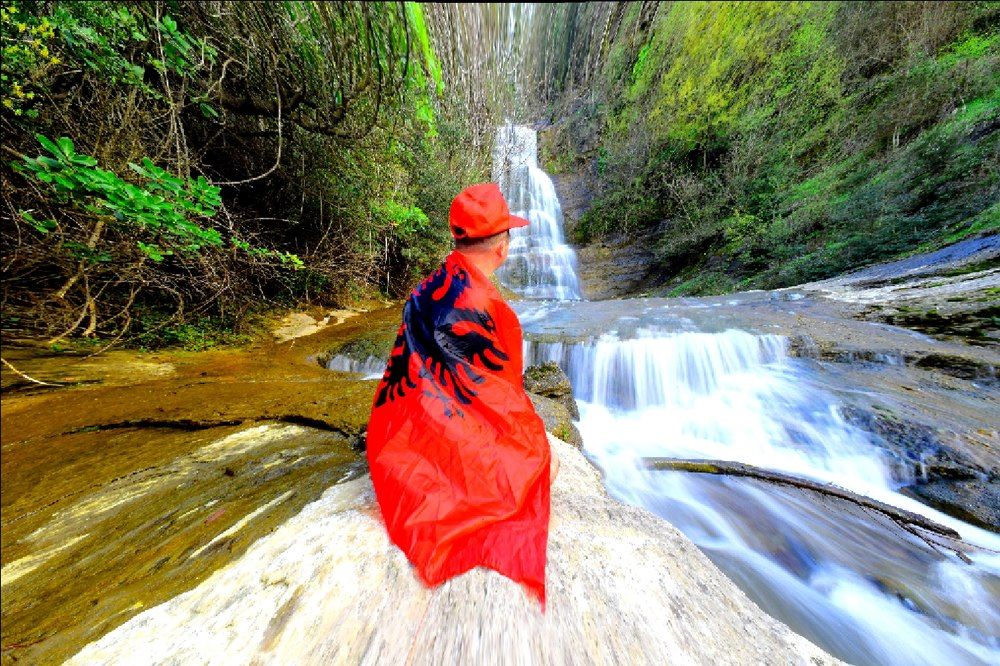 Albanian admiring the waterfall.