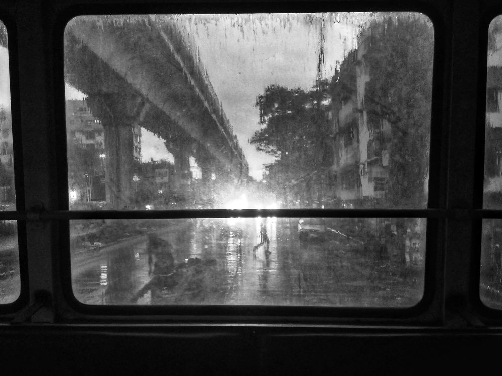 A rainy day viewed from a bus