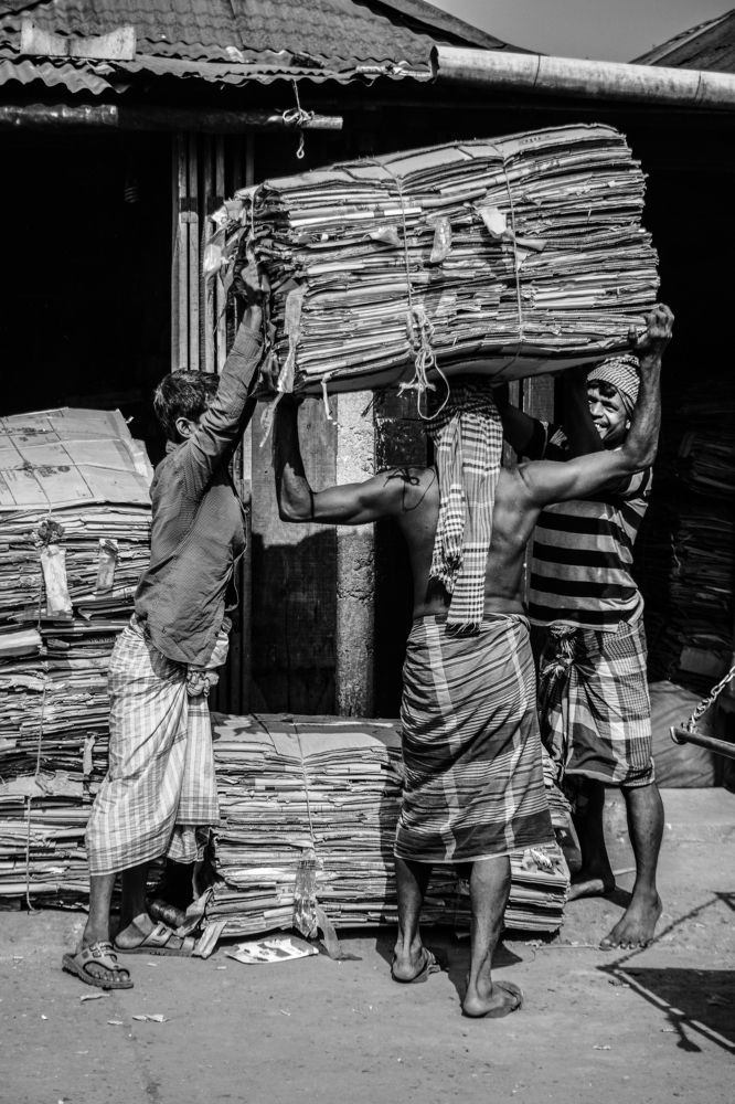 Two worker help their collegue (Life of Bangladesh)